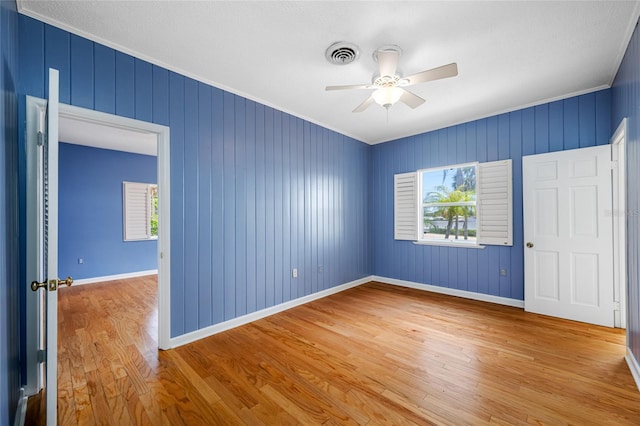 401 Whitcomb Blvd, Tarpon Springs, FL 34689 - empty room featuring wood finished floors, a ceiling fan, baseboards, and crown molding