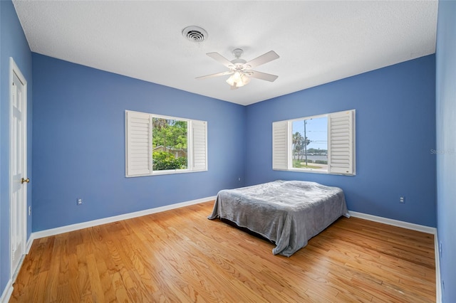 401 Whitcomb Blvd, Tarpon Springs, FL 34689 - bedroom featuring baseboards, wood finished floors, and a ceiling fan