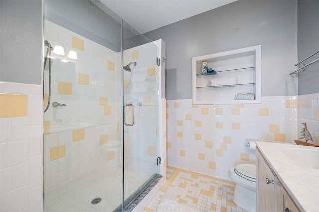 401 Whitcomb Blvd, Tarpon Springs, FL 34689 - bathroom featuring tile walls, a stall shower, toilet, vanity, and wainscoting