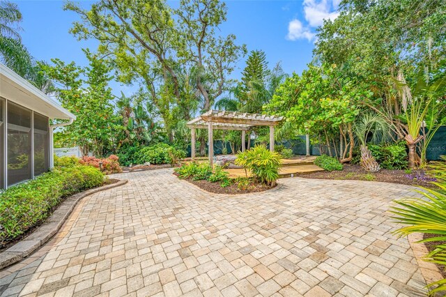 401 Whitcomb Blvd, Tarpon Springs, FL 34689 - view of patio / terrace featuring a pergola, a sunroom, and fence