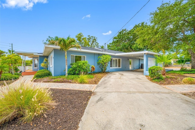 401 Whitcomb Blvd, Tarpon Springs, FL 34689 - view of front of home featuring stucco siding, driveway, and an attached carport