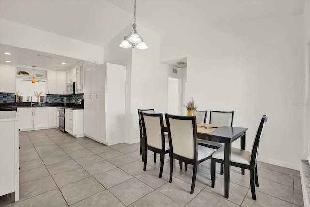 5875 Darren Ct N, Clearwater, FL 33760 - dining room with light tile patterned floors, vaulted ceiling, a chandelier, baseboards, and recessed lighting