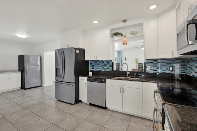 5875 Darren Ct N, Clearwater, FL 33760 - kitchen featuring appliances with stainless steel finishes, a sink, a ceiling fan, and white cabinetry