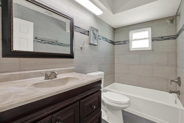 5875 Darren Ct N, Clearwater, FL 33760 - bathroom featuring toilet, bathing tub / shower combination, vanity, and tile walls