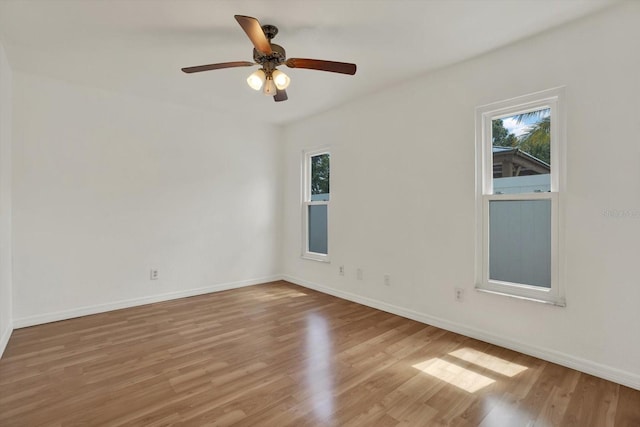 5875 Darren Ct N, Clearwater, FL 33760 - spare room with healthy amount of natural light, wood finished floors, baseboards, and a ceiling fan