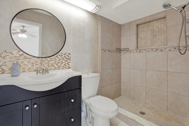 5875 Darren Ct N, Clearwater, FL 33760 - full bathroom with a tile shower, ceiling fan, toilet, vanity, and tile walls