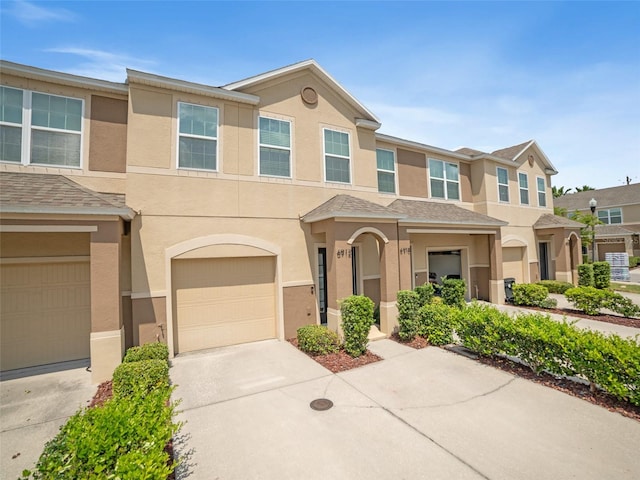 6912 40th Ln N, Pinellas Park, FL 33781 - view of property with stucco siding, concrete driveway, and an attached garage