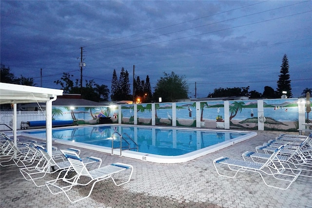 community pool featuring fence and a patio area