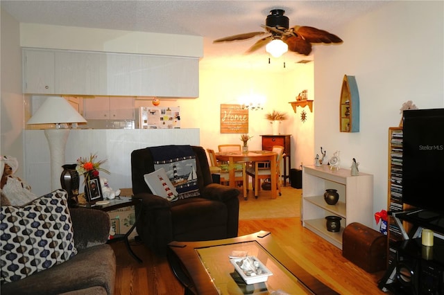 living room with a ceiling fan and wood finished floors
