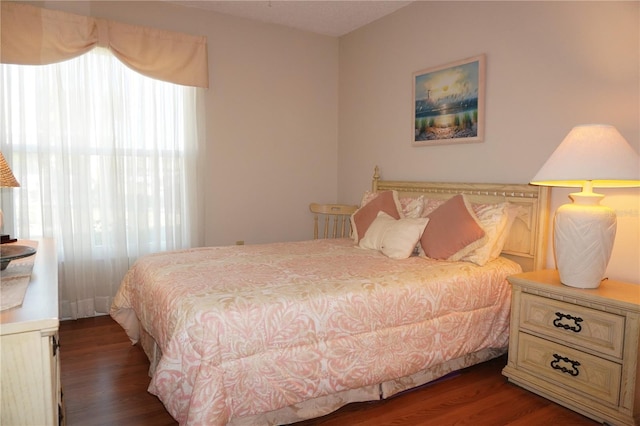 bedroom featuring dark wood-style flooring