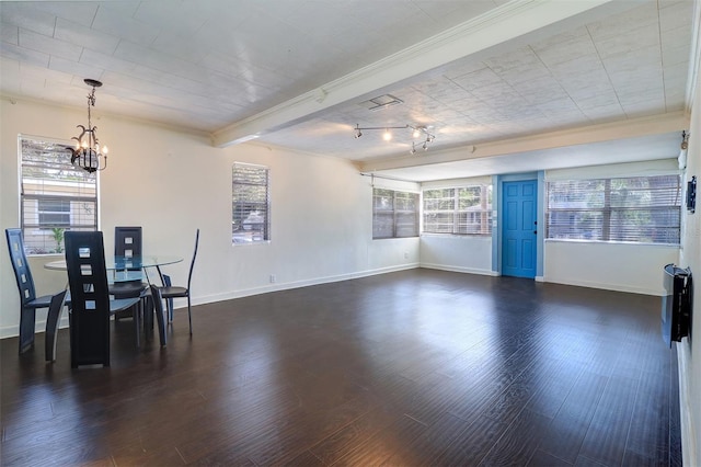 520 4th St NW, Largo, FL 33770 - unfurnished dining area with a chandelier, baseboards, crown molding, and dark wood-type flooring