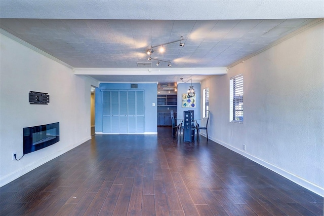 520 4th St NW, Largo, FL 33770 - unfurnished living room with a glass covered fireplace, wood finished floors, baseboards, and ornamental molding
