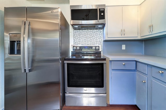 520 4th St NW, Largo, FL 33770 - kitchen featuring appliances with stainless steel finishes, light countertops, tasteful backsplash, and white cabinets