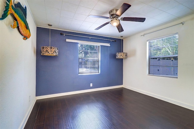 520 4th St NW, Largo, FL 33770 - spare room with a ceiling fan, wood finished floors, and baseboards