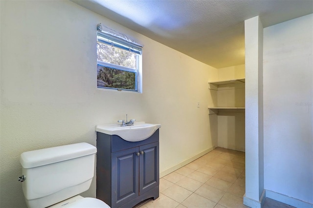 520 4th St NW, Largo, FL 33770 - bathroom with toilet, baseboards, vanity, and tile patterned floors