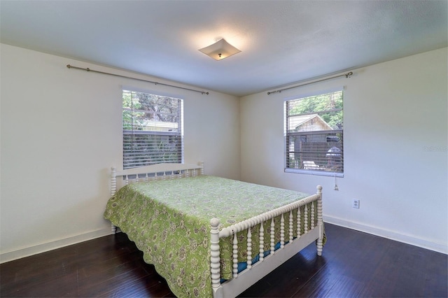 520 4th St NW, Largo, FL 33770 - bedroom featuring baseboards and wood finished floors