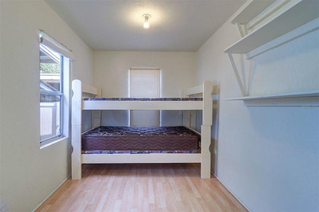 520 4th St NW, Largo, FL 33770 - unfurnished bedroom with wood finished floors and baseboards
