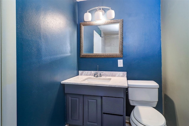 520 4th St NW, Largo, FL 33770 - bathroom with toilet, vanity, and a textured wall