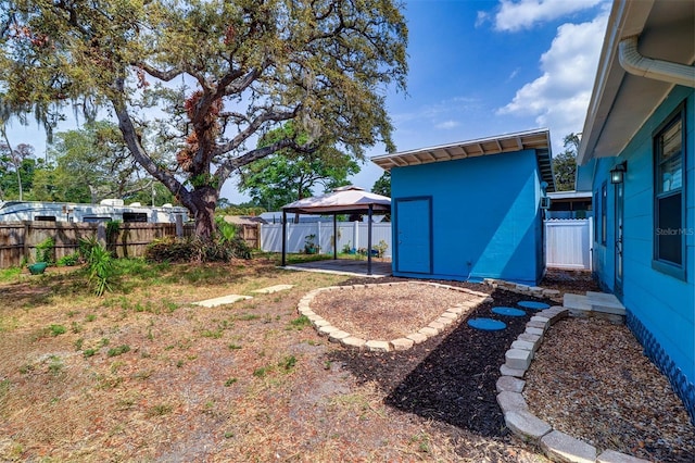 520 4th St NW, Largo, FL 33770 - fenced backyard with a gazebo, an outbuilding, and a patio area