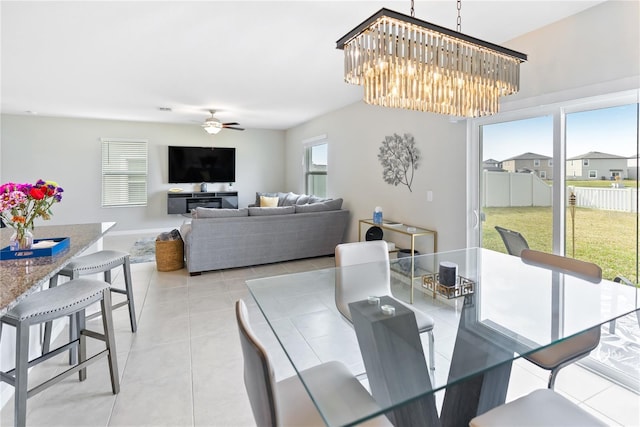 9313 Lemon Drop Loop, Sun City Center, FL 33573 - dining room with light tile patterned flooring, ceiling fan, a chandelier, and baseboards