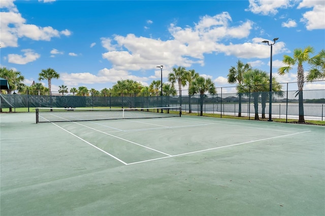 9313 Lemon Drop Loop, Sun City Center, FL 33573 - view of tennis court with fence and community basketball court