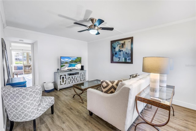 7801 11th St N Unit 104, Saint Petersburg, FL 33702 - living area featuring crown molding, wood finished floors, ceiling fan, and baseboards