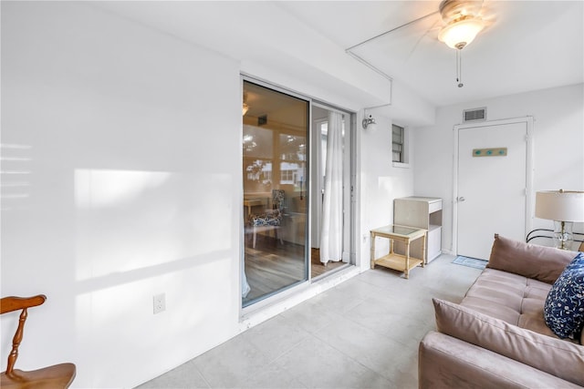 7801 11th St N Unit 104, Saint Petersburg, FL 33702 - living room featuring a ceiling fan and tile patterned floors
