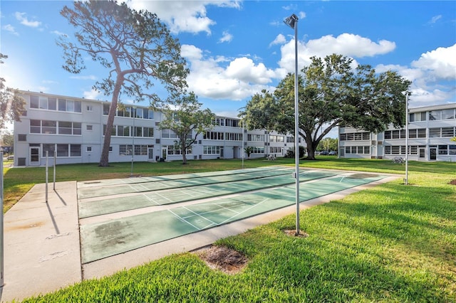 7801 11th St N Unit 104, Saint Petersburg, FL 33702 - surrounding community with a yard and shuffleboard