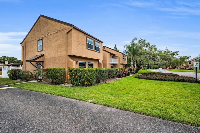 1864 Clearbrooke Dr, Clearwater, FL 33760 - view of property exterior featuring a yard, stucco siding, and a wall mounted AC