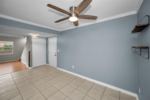 1864 Clearbrooke Dr, Clearwater, FL 33760 - spare room with light tile patterned floors, a textured ceiling, a ceiling fan, crown molding, and baseboards