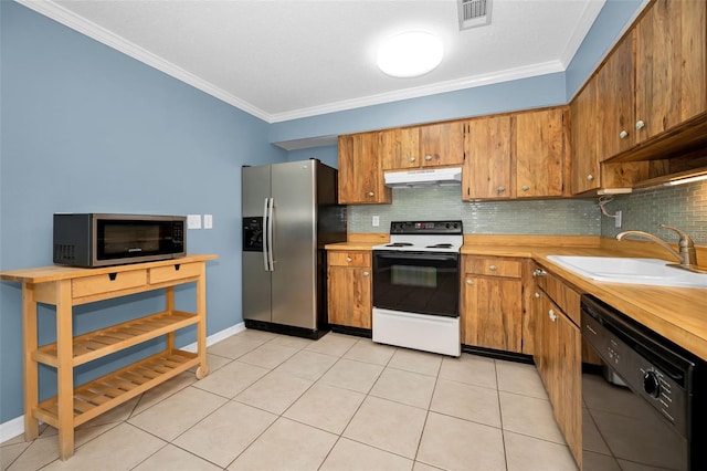 1864 Clearbrooke Dr, Clearwater, FL 33760 - kitchen with stainless steel appliances, under cabinet range hood, a sink, light countertops, and decorative backsplash