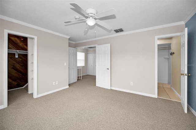 1864 Clearbrooke Dr, Clearwater, FL 33760 - unfurnished bedroom featuring a spacious closet, carpet, ornamental molding, baseboards, and a textured ceiling