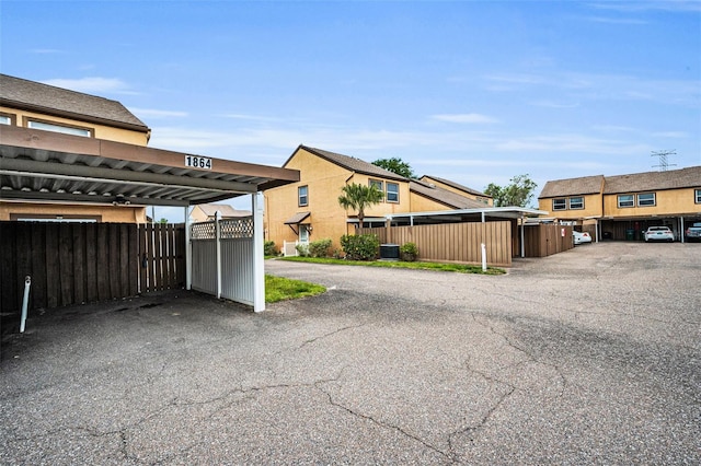 1864 Clearbrooke Dr, Clearwater, FL 33760 - view of front facade featuring covered parking, fence, and cooling unit