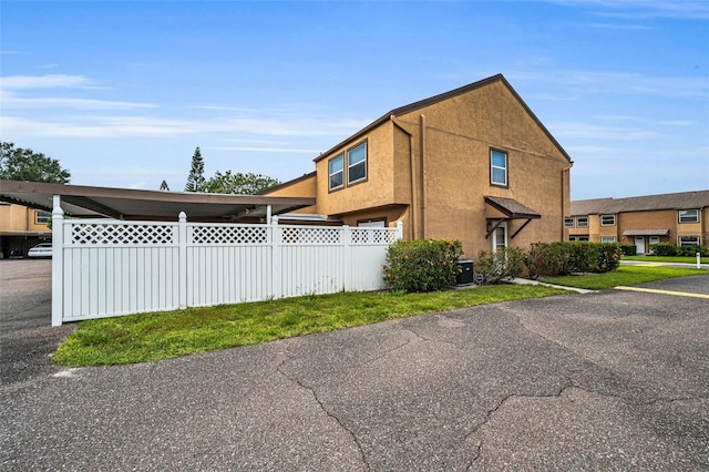 1864 Clearbrooke Dr, Clearwater, FL 33760 - view of side of property with fence, stucco siding, and central air condition unit
