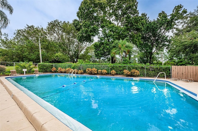 1864 Clearbrooke Dr, Clearwater, FL 33760 - community pool featuring fence and view of wooded area