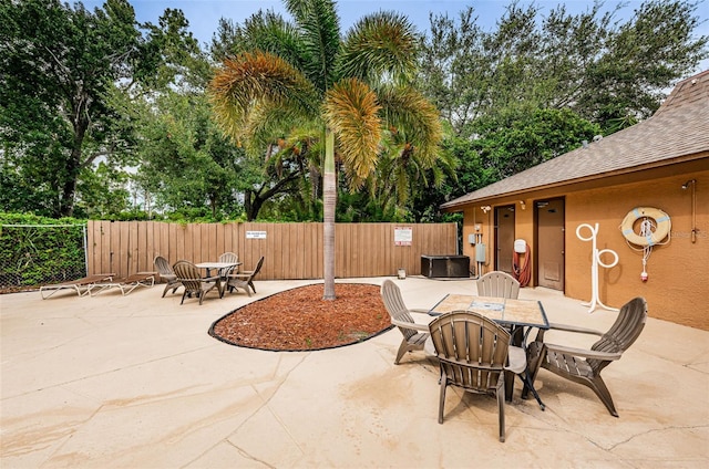 1864 Clearbrooke Dr, Clearwater, FL 33760 - view of patio featuring outdoor dining area, fence, and central air condition unit