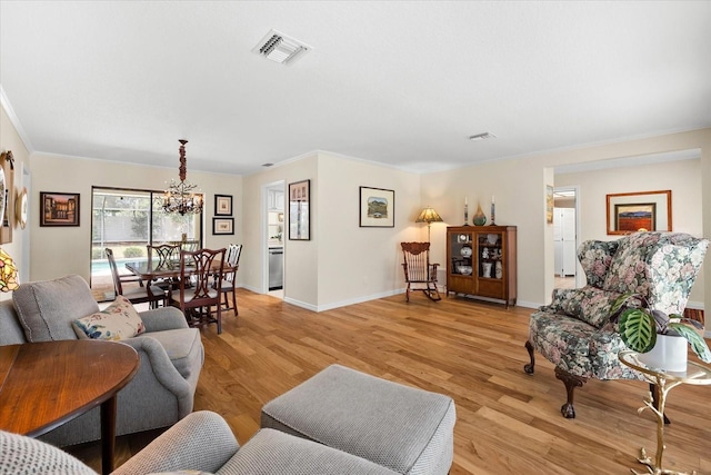 535 Sandy Hook, Palm Harbor, FL 34683 - living room featuring a chandelier, crown molding, light wood-type flooring, and baseboards