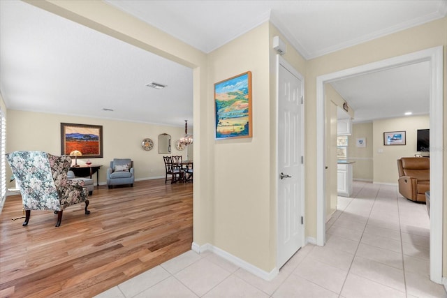 535 Sandy Hook, Palm Harbor, FL 34683 - corridor with light tile patterned floors, a chandelier, ornamental molding, and baseboards