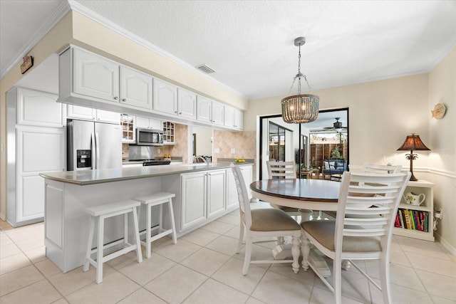 535 Sandy Hook, Palm Harbor, FL 34683 - dining space featuring a chandelier, light tile patterned floors, and ornamental molding
