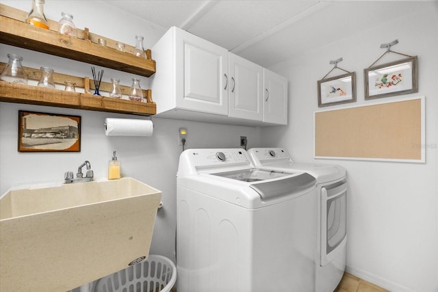 535 Sandy Hook, Palm Harbor, FL 34683 - washroom featuring cabinet space, washer and dryer, and light tile patterned floors