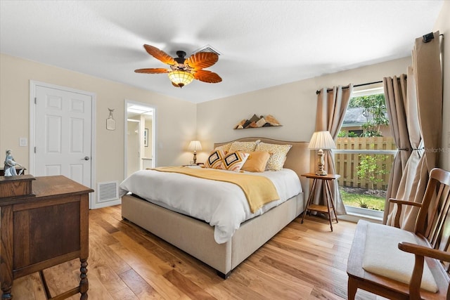 535 Sandy Hook, Palm Harbor, FL 34683 - bedroom featuring light wood-type flooring, connected bathroom, and ceiling fan