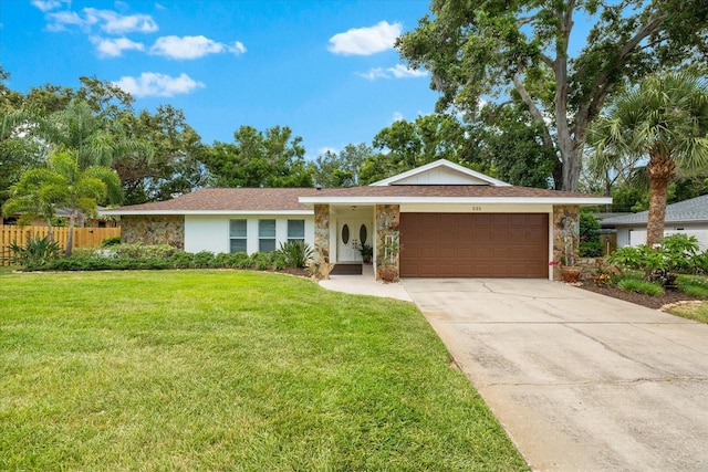 535 Sandy Hook, Palm Harbor, FL 34683 - ranch-style home with a garage, stone siding, and driveway