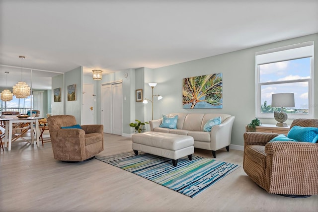 living room with light wood-type flooring and baseboards