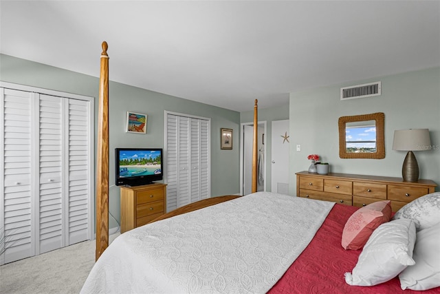 bedroom featuring two closets and carpet floors
