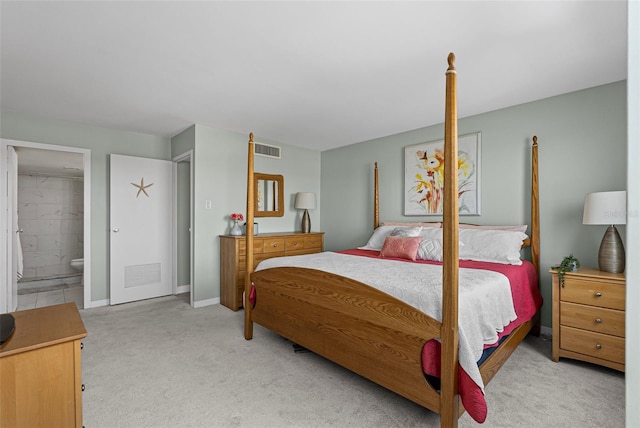carpeted bedroom with baseboards and connected bathroom