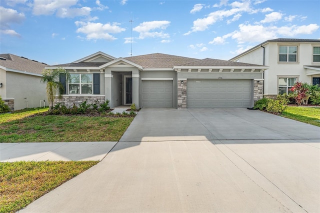 view of front of home featuring a garage, stucco siding, stone siding, and driveway