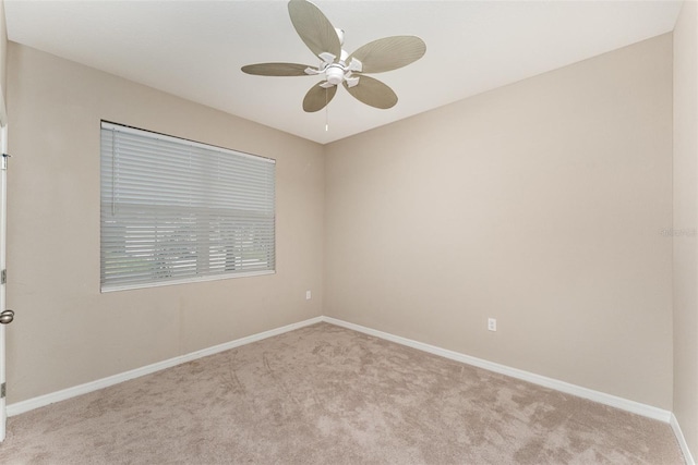 spare room featuring carpet flooring, ceiling fan, and baseboards
