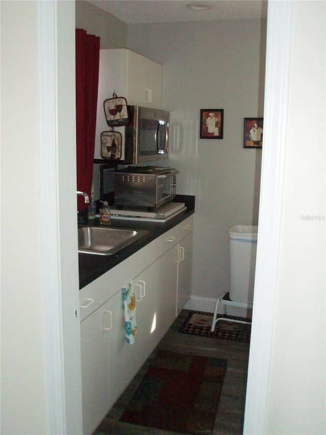 2980 Haines Bayshore Rd Unit 124, Clearwater, FL 33760 - bathroom with a sink, baseboards, and toilet