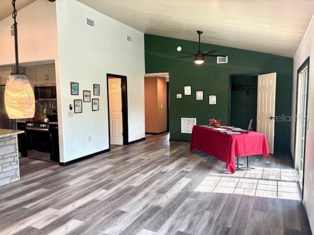 6906 W Barbara Ann Ln, Homosassa, FL 34446 - living area with ceiling fan, wood finished floors, high vaulted ceiling, and baseboards