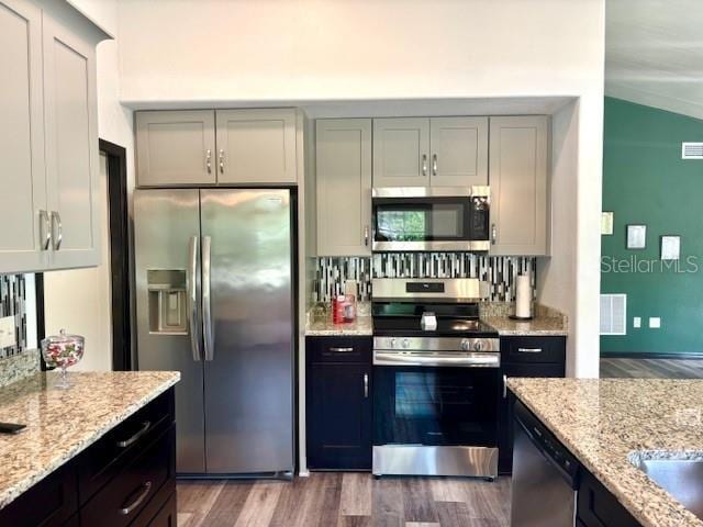 6906 W Barbara Ann Ln, Homosassa, FL 34446 - kitchen featuring stainless steel appliances, dark wood-style floors, and light stone counters